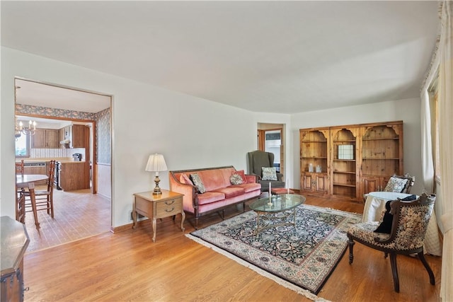639 Scenery Dr, Elizabeth Twp/Boro, PA 15037 - living area with a chandelier, wood finished floors, and baseboards