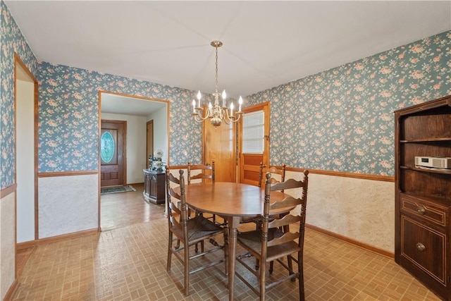639 Scenery Dr, Elizabeth Twp/Boro, PA 15037 - dining room with wallpapered walls, brick patterned flooring, a chandelier, and baseboards