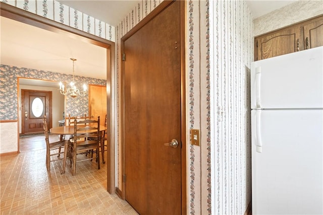 639 Scenery Dr, Elizabeth Twp/Boro, PA 15037 - hall with wallpapered walls, a chandelier, and brick patterned flooring