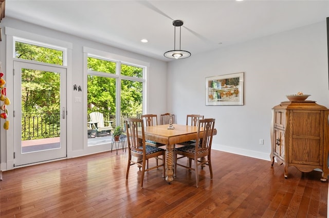dining space featuring wood finished floors, recessed lighting, and baseboards