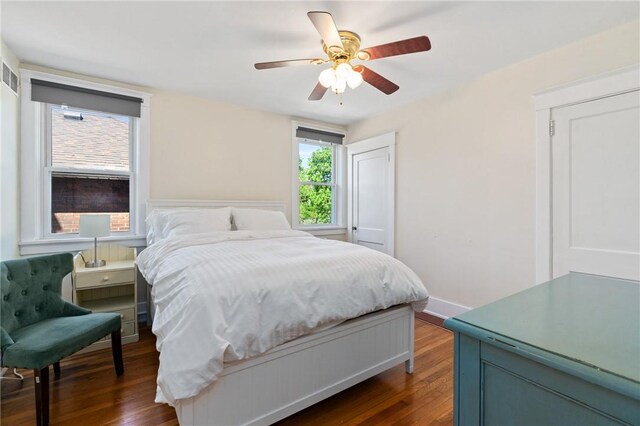 bedroom with dark wood-style flooring and a ceiling fan