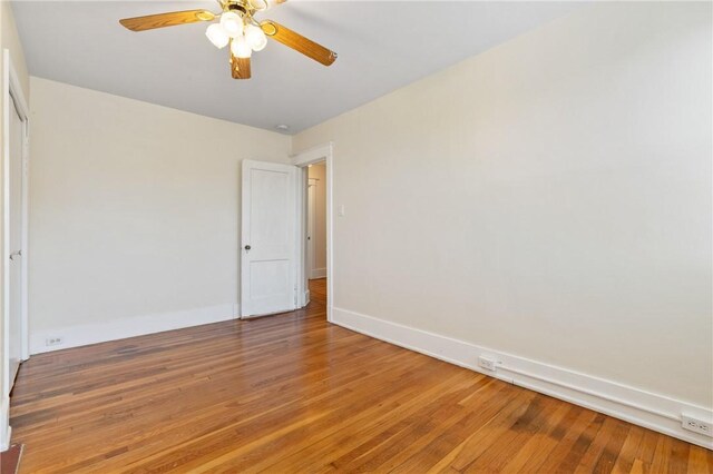 unfurnished bedroom with light wood-type flooring, baseboards, and a ceiling fan