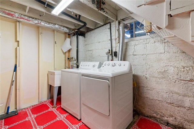laundry room featuring separate washer and dryer and tile patterned floors