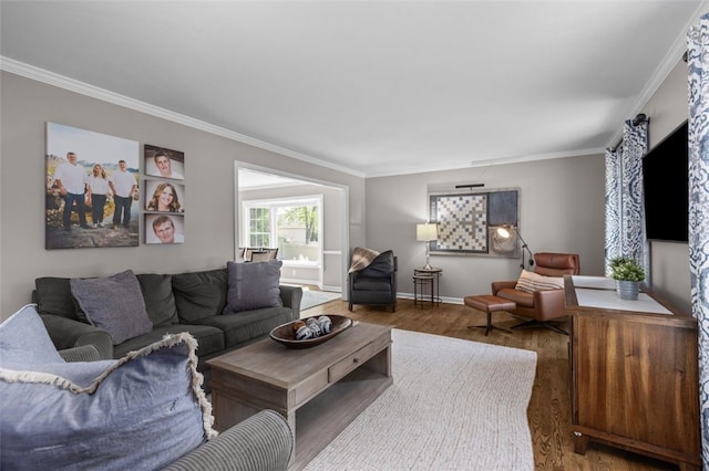 living room with ornamental molding, wood finished floors, and baseboards