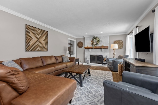 living area featuring wood finished floors, ornamental molding, recessed lighting, and a fireplace