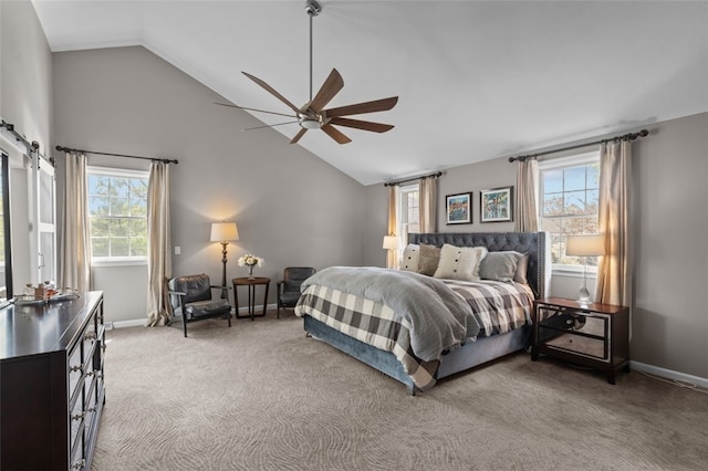 bedroom featuring lofted ceiling, multiple windows, light carpet, and a ceiling fan