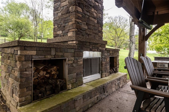 view of patio with an outdoor stone fireplace
