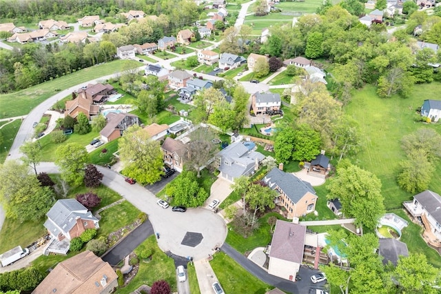aerial view of property and surrounding area with nearby suburban area