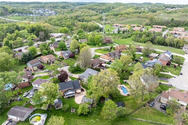 aerial view of property's location with nearby suburban area and a forest