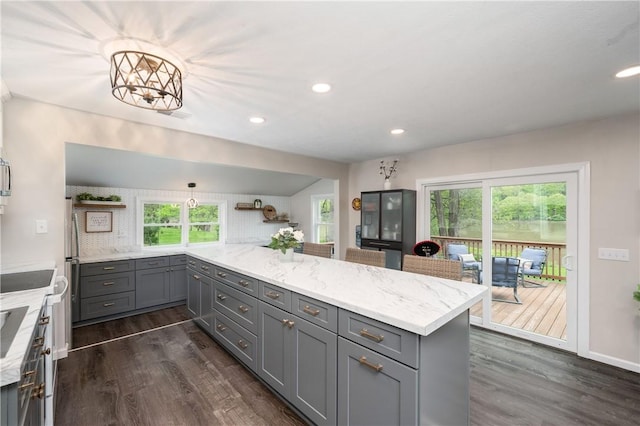 kitchen featuring gray cabinetry, dark wood finished floors, plenty of natural light, and recessed lighting