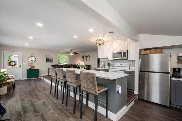 145 Robinson Pl, Perry Twp Arm, PA 16041 - kitchen featuring appliances with stainless steel finishes, a kitchen breakfast bar, dark wood finished floors, a kitchen island, and recessed lighting