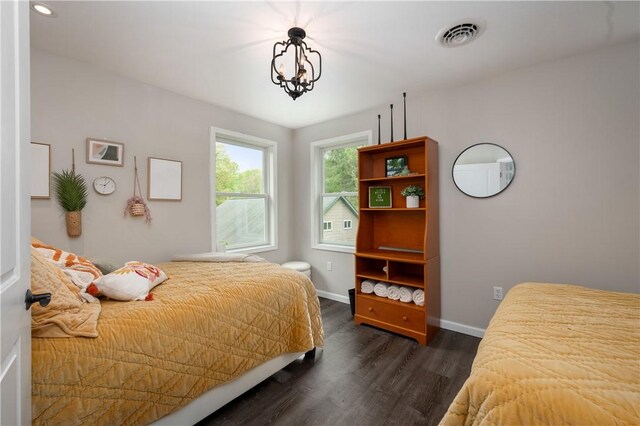 145 Robinson Pl, Perry Twp Arm, PA 16041 - bedroom with dark wood-type flooring, baseboards, and a chandelier
