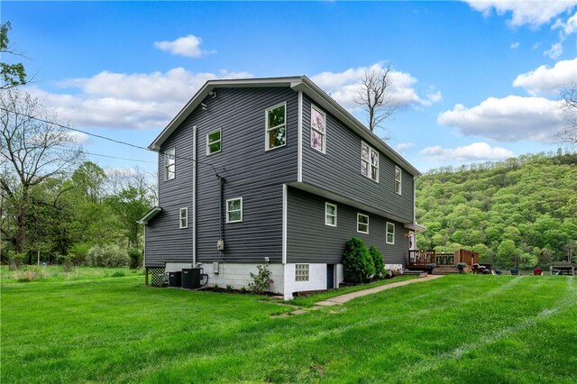 145 Robinson Pl, Perry Twp Arm, PA 16041 - view of home's exterior with central AC unit, a wooden deck, and a yard