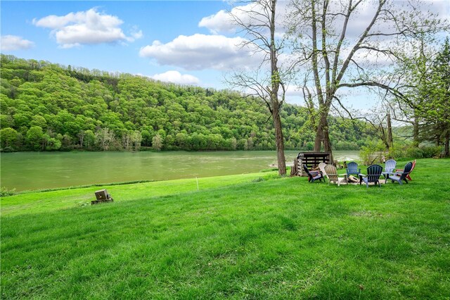 145 Robinson Pl, Perry Twp Arm, PA 16041 - view of green lawn with a water view, an outdoor fire pit, and a view of trees