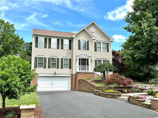 111 Cherrywood Dr, Plum Boro, PA 15068 - colonial house featuring an attached garage, driveway, and brick siding