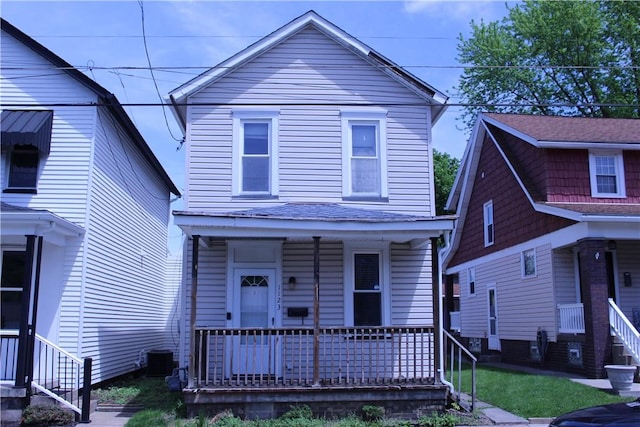 view of front of house with a porch and cooling unit