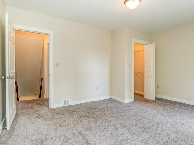411 4th St, Darlington, PA 16115 - unfurnished bedroom featuring carpet flooring, a walk in closet, baseboards, and a closet