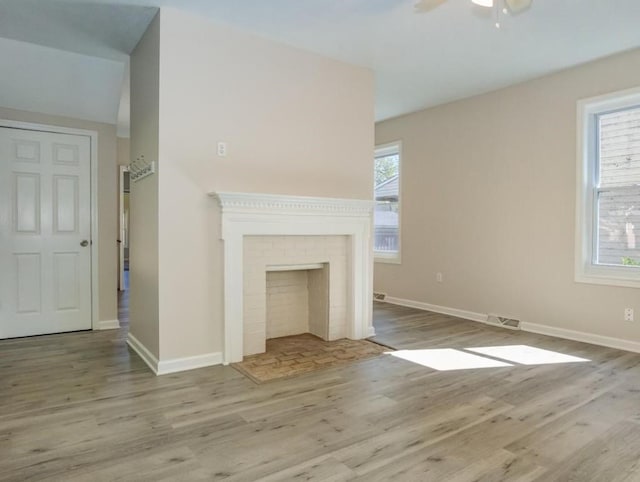411 4th St, Darlington, PA 16115 - unfurnished living room with wood finished floors, a ceiling fan, baseboards, and a fireplace