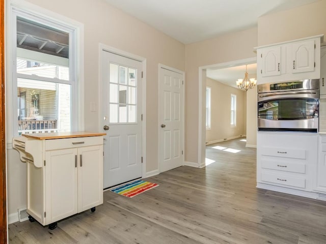 411 4th St, Darlington, PA 16115 - entryway with a chandelier, light wood-style flooring, and baseboards