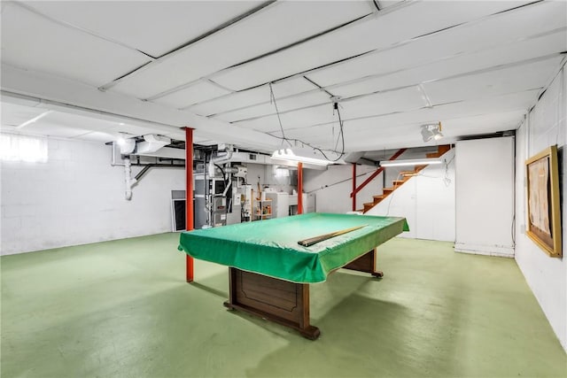 rec room with finished concrete floors, billiards table, washing machine and clothes dryer, and heating unit