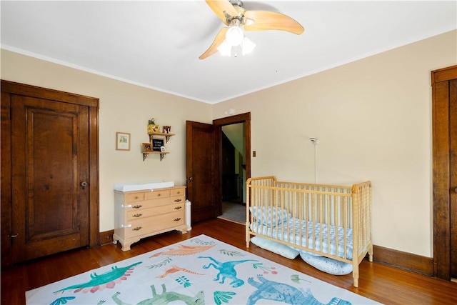 16 Morgan Ave E, Washington Boro, PA 15301 - bedroom with dark wood-style flooring, ornamental molding, baseboards, ceiling fan, and a crib