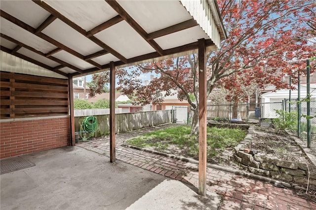 view of patio featuring fence and a gate