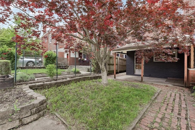 view of yard with fence and a patio