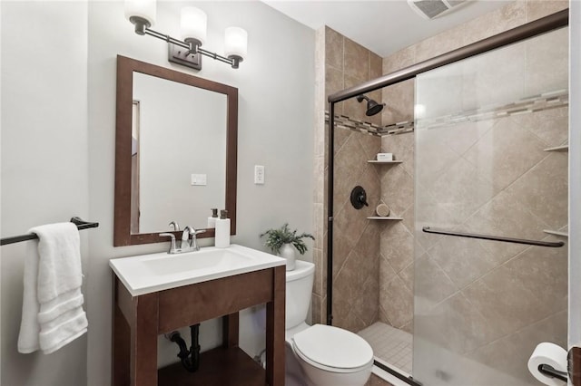 full bathroom featuring a shower stall, toilet, and a sink