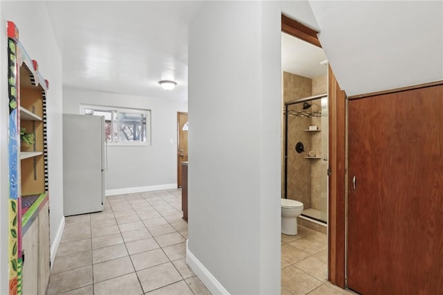 corridor with light tile patterned floors and baseboards