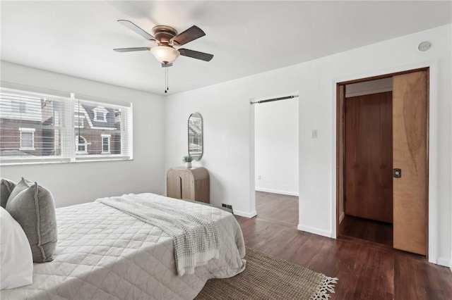 bedroom featuring wood finished floors, baseboards, and ceiling fan