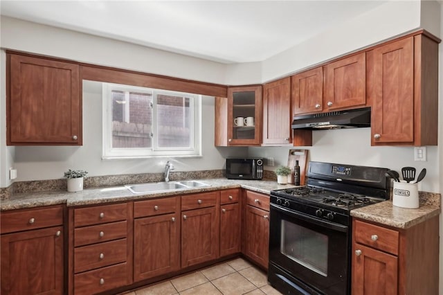 kitchen featuring black appliances, under cabinet range hood, a sink, light tile patterned floors, and brown cabinets