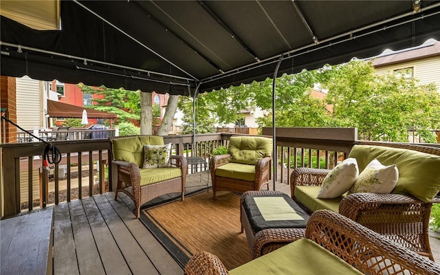 wooden terrace featuring an outdoor hangout area