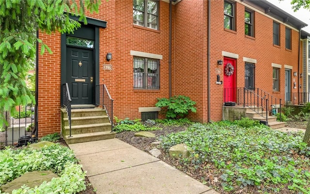 view of exterior entry with brick siding
