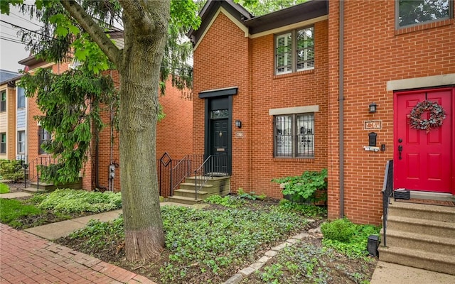entrance to property featuring brick siding