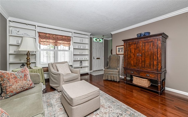 living area featuring crown molding, wood finished floors, a textured ceiling, and baseboards
