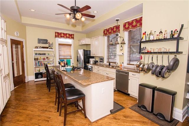 301 Meyers Ave, Meyersdale Boro, PA 15552 - kitchen with appliances with stainless steel finishes, ceiling fan, a kitchen bar, a sink, and a center island