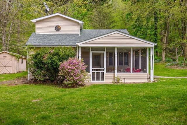 192 Wilkins Hollow Rd, Addison Twp, PA 15411 - back of house featuring roof with shingles, a storage unit, a sunroom, a yard, and an outbuilding