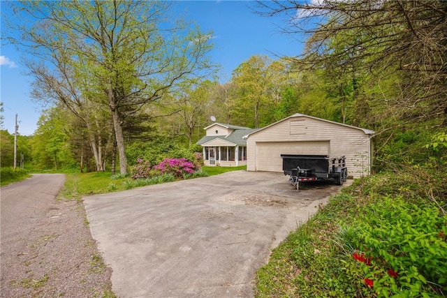 192 Wilkins Hollow Rd, Addison Twp, PA 15411 - view of front facade featuring a detached garage and a wooded view