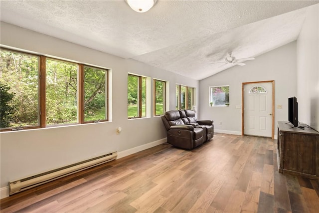192 Wilkins Hollow Rd, Addison Twp, PA 15411 - sitting room with baseboard heating, a textured ceiling, ceiling fan, vaulted ceiling, and light wood-style floors