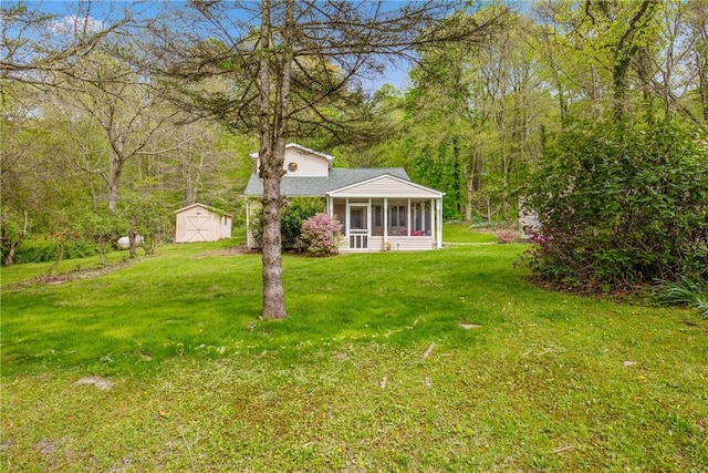 192 Wilkins Hollow Rd, Addison Twp, PA 15411 - view of green lawn with a sunroom, a storage unit, and an outbuilding