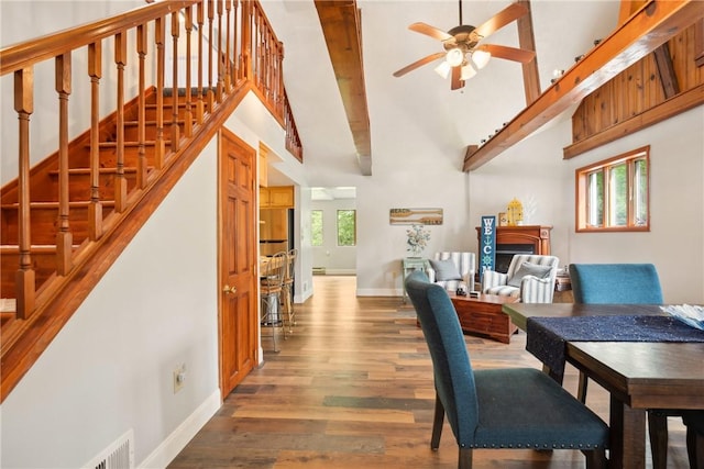 192 Wilkins Hollow Rd, Addison Twp, PA 15411 - dining area featuring wood finished floors, ceiling fan, a high ceiling, baseboards, and stairway