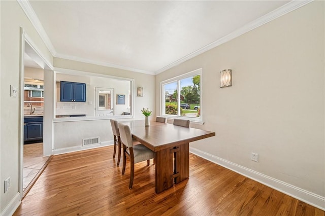 4625 Doverdell Dr, Whitehall, PA 15236 - dining area featuring light wood finished floors, crown molding, and baseboards