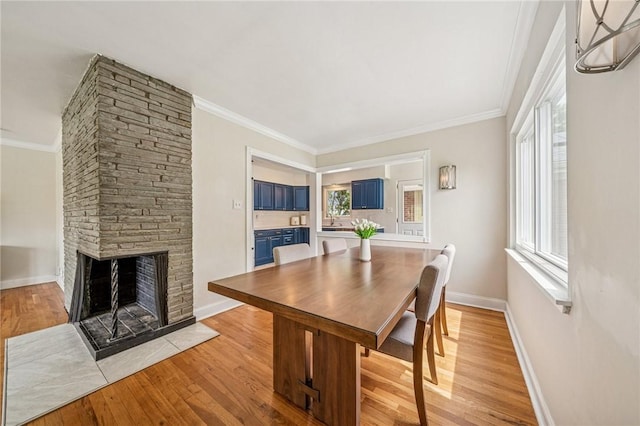 4625 Doverdell Dr, Whitehall, PA 15236 - dining room featuring light wood finished floors, a fireplace, ornamental molding, and baseboards