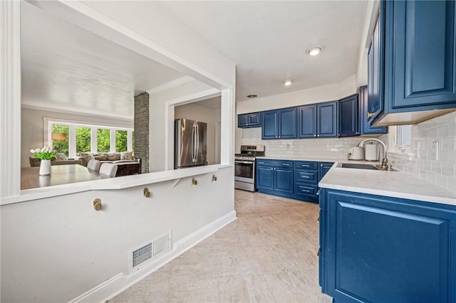 4625 Doverdell Dr, Whitehall, PA 15236 - kitchen featuring stainless steel appliances, a sink, blue cabinets, tasteful backsplash, and light countertops