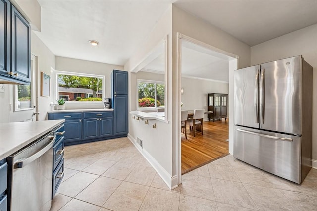 4625 Doverdell Dr, Whitehall, PA 15236 - kitchen with appliances with stainless steel finishes, blue cabinets, light tile patterned floors, light countertops, and baseboards
