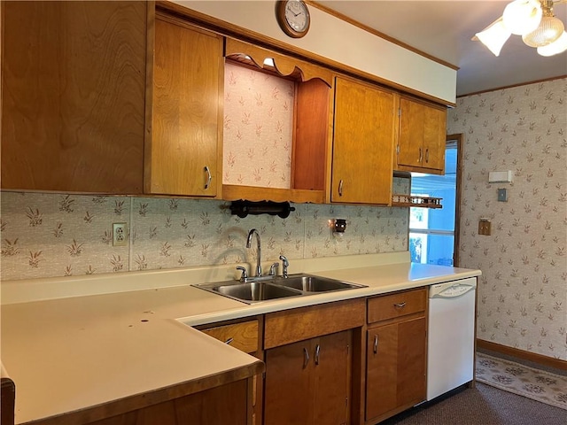 kitchen with white dishwasher, a sink, light countertops, brown cabinetry, and wallpapered walls