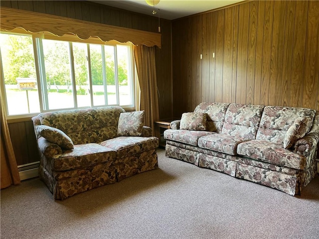 carpeted living room with wood walls, healthy amount of natural light, and baseboard heating