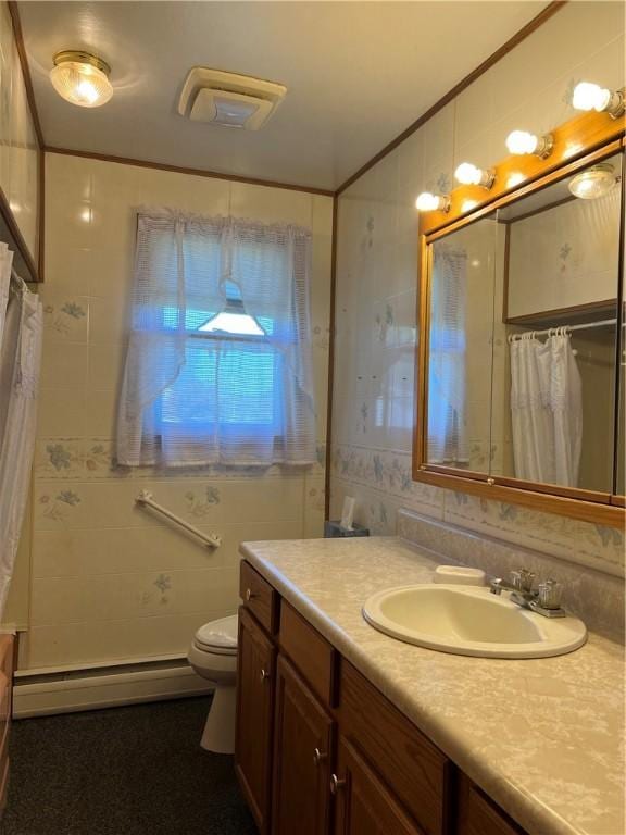 full bath with baseboard heating, vanity, toilet, tile walls, and a shower with curtain