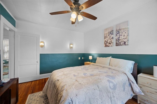 bedroom with wood finished floors and a ceiling fan