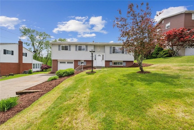 bi-level home featuring driveway, an attached garage, and a front lawn